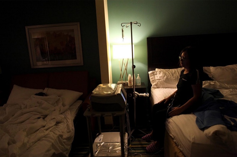 Puerto Rican Waleska Rivera, 42, undergoes her dialysis treatment in a hotel room, where she lives with her family.