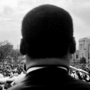 Dr. Martin Luther King Jr. Looks out at 25000+ crowd of civil rights marchers in Montgomery, 1965.