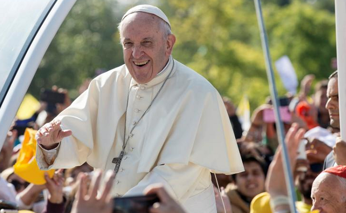 Pope Francis waves to people as he arrives at O'Higgins park where he will lead a mass, in Santiago, Chile.