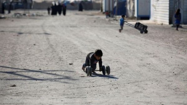 A displaced Iraqi boy plays at the Amriyat al Fallujah camp in Anbar Province, Iraq Jan. 3, 2018.