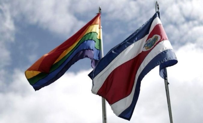 The rainbow flag, which symbolizes sexual diversity, is seen after being raised by Costa Rica's President Luis Guillermo Solis, next to Costa Rica's national flag at the presidential house in San Jose.