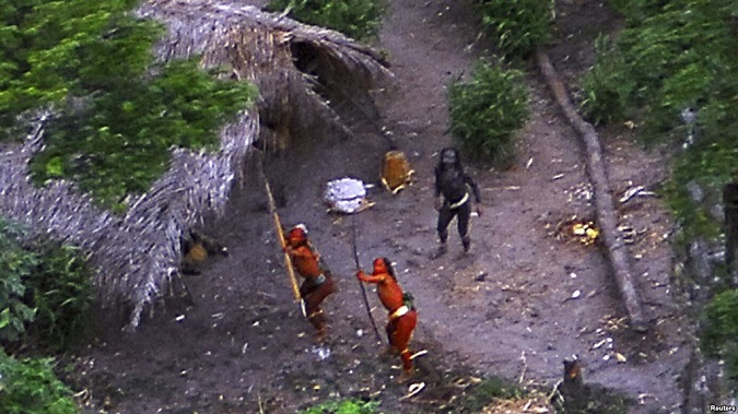 Members of an uncontacted Amazon Basin tribe and their dwellings are seen in the Brazilian state of Acre along the border with Peru in 2008.