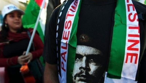 Che Guevara's face is seen alongside Palestine flags at a solidarity rally in Nicaragua. 