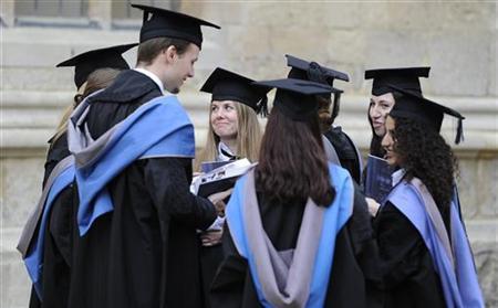 A group of graduates gather outside the Sheldonian Theatre after a graduation ceremony at Oxford University, Oxford, England, May 28, 2011.