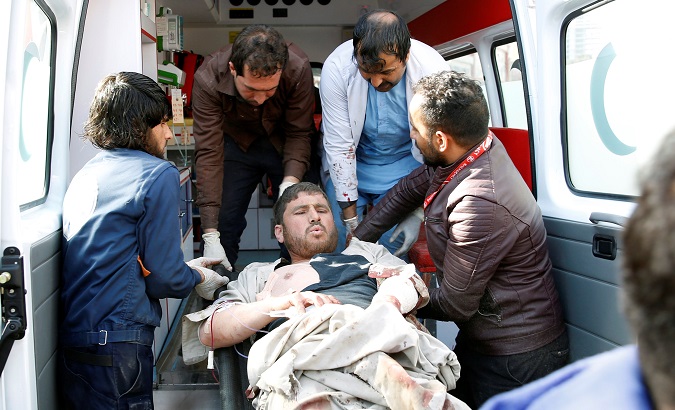 People carry an injured man to a hospital after a blast in Kabul, Afghanistan Jan. 27, 2018.