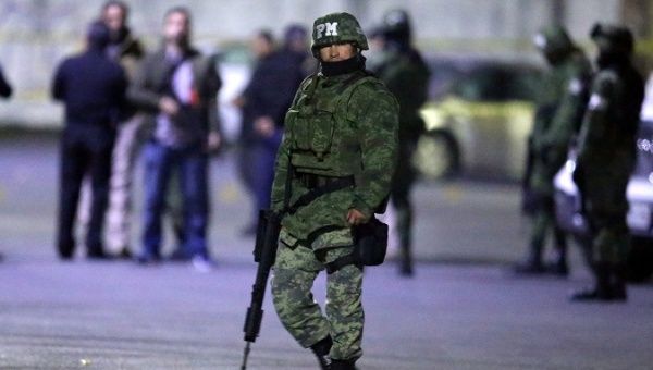A soldier stands guard next to a crime scene, where men were killed inside a home by unknown assailants, in the municipality of San Nicolas de los Garza, Mexico, January 27, 2018.