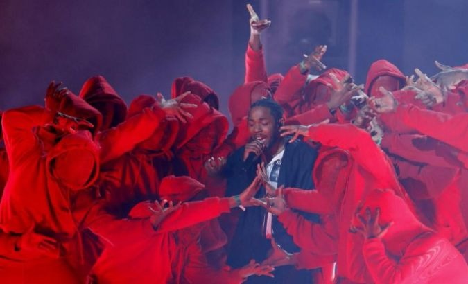 Lamar was accompanied by dancers clad in red for a special choreography in which each player mimicked being fatally struck by gunshots.