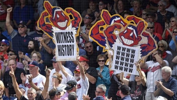 Fans hold signs in the first inning of a game between the Cleveland Indians and the Detroit Tigers at Progressive Field. 