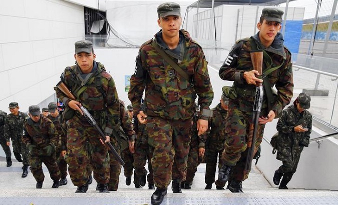 Brazilian soldiers hold weapons as they are deployed to provide security at the Corinthians arena in Sao Paulo.