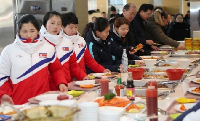 North and South Korea women's ice hockey athletes stand in a line at a dining hall at the Jincheon National Training Centre in Jincheon, South Korea.