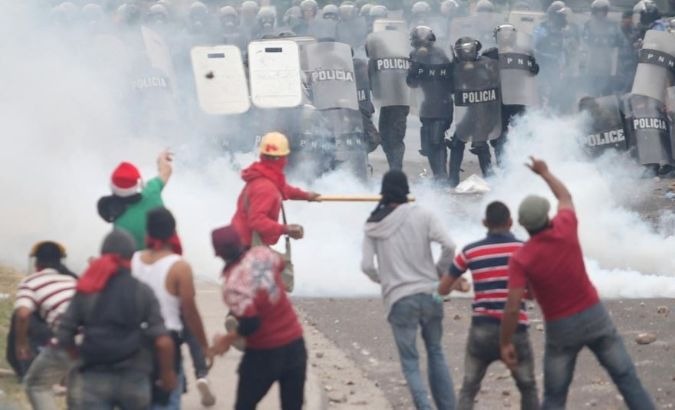 Honduras riot police and protestors clash following the disputed 2017 presidential elections.