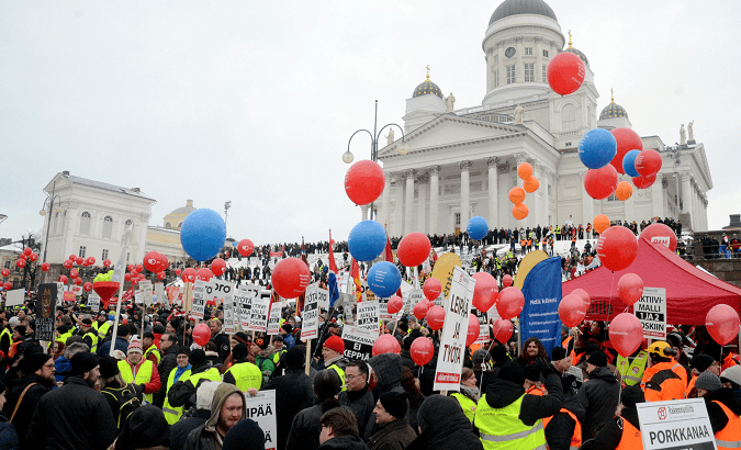 People demonstrate against unemployment benefit cuts in Helsinki.