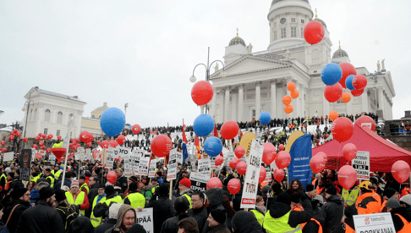 People demonstrate against unemployment benefit cuts in Helsinki.