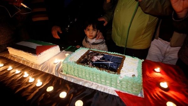 Palestinians take part in a symbolic birthday party for Palestinian teen Ahed Tamimi, who is detained by Israel, in the West Bank city of Hebron Jan. 30, 2018.