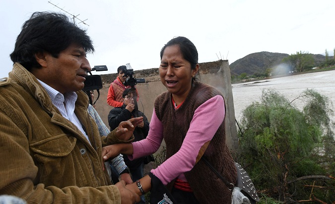 A woman cries as she shakes hands with Bolivia's President Evo Morales in Tupiza after heavy rains caused floods, Tupiza, Potosi, Bolivia, January 2, 2018.