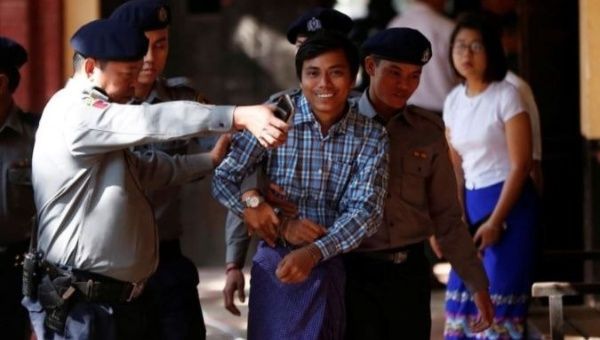 Detained Reuters journalist Kyaw Soe Oo escorted by police, arrives for a court hearing in Yangon, Myanmar.