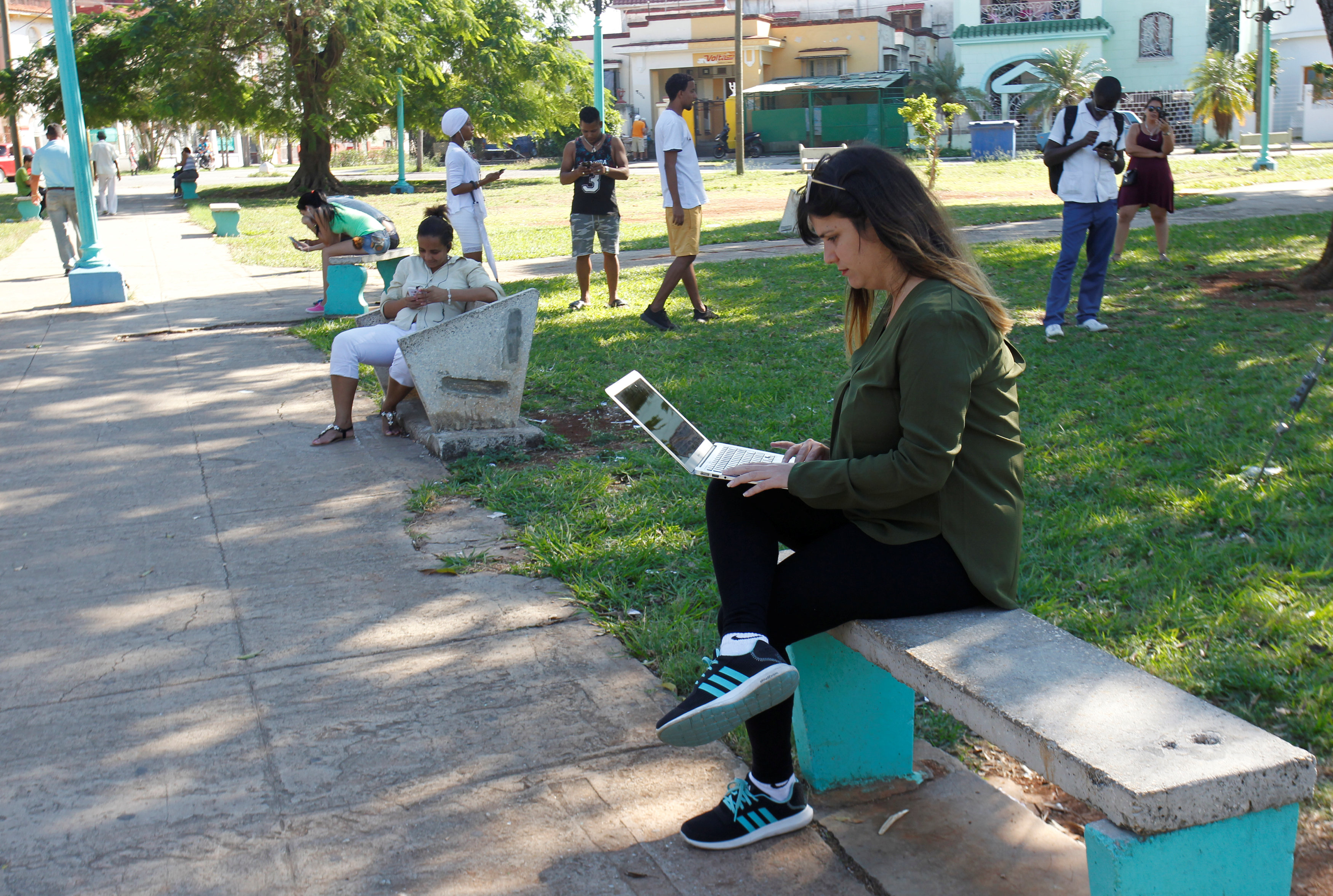 Elaine Diaz, who founded web-based outlet Periodismo de Barrio in 2015, connects to the internet at a hotspot in Havana, Cuba, February 5.