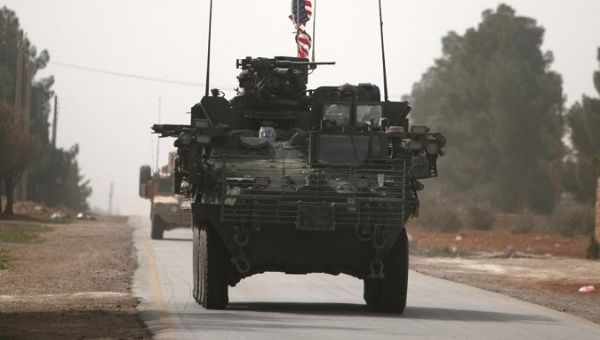 U.S. army vehicles drive north of Manbij city, in Aleppo Governorate, Syria. 