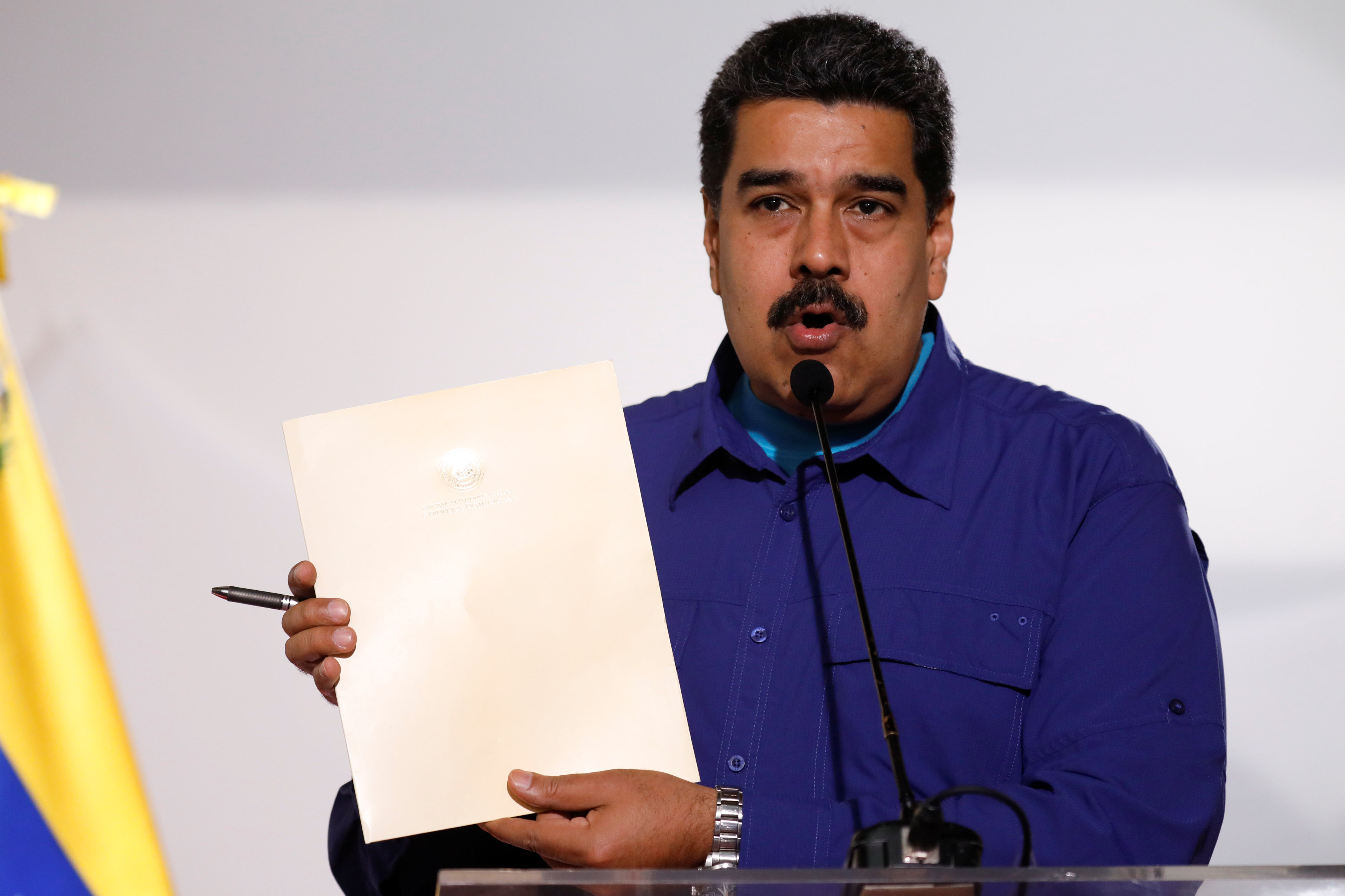 Venezuela's President Nicolas Maduro holds a document as he talks to the media before an event with supporters of Somos Venezuela (We are Venezuela) movement in Caracas, Venezuela February 7, 2018.