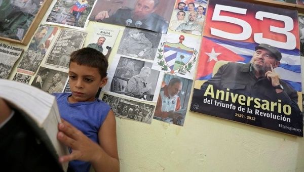 Marlon Mendez, an admirer of Fidel Castro, reads a book in his bedroom in San Antonio de los Banos, Cuba.