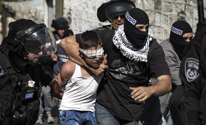 Israeli police detain a Palestinian child in Jerusalem following clashes in the holy city in late Oct. 2014.