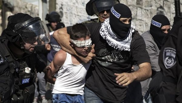 Israeli police detain a Palestinian child in Jerusalem following clashes in the holy city in late Oct. 2014. 