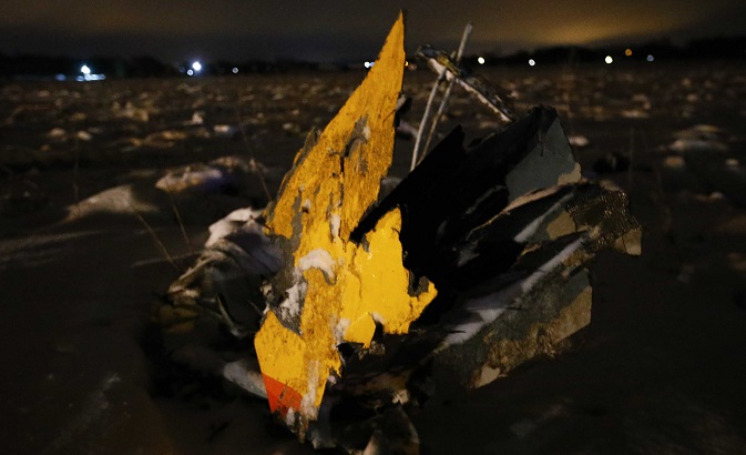 A part of a Saratov Airlines Antonov AN-148 plane that crashed after taking off from Moscow's Domodedovo airport. Investigators were also on the scene looking into why the plane went down early Sunday morning. Feb. 11, 2018.