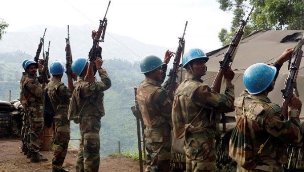 Indian soldiers, serving in the U.N. peacekeeping mission in Congo (MONUSCO), hold up their weapons at their base after patrolling the villages in Masisi