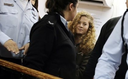 Palestinian teen Ahed Tamimi enters a military courtroom escorted by Israeli police at Ofer Prison, near the West Bank city of Ramallah, Feb. 13, 2018. 