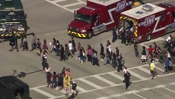 Students are evacuated from Marjory Stoneman Douglas High School during a shooting incident in Parkland, Florida, U.S. February 14, 2018 in a still image from video.