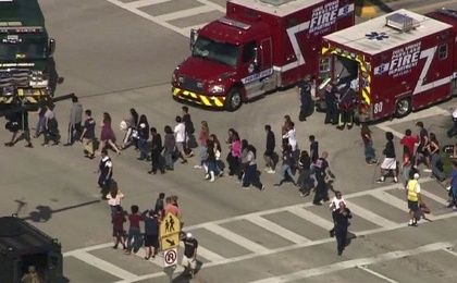 Students are evacuated from Marjory Stoneman Douglas High School during a shooting incident in Parkland, Florida, U.S. February 14, 2018 in a still image from video.