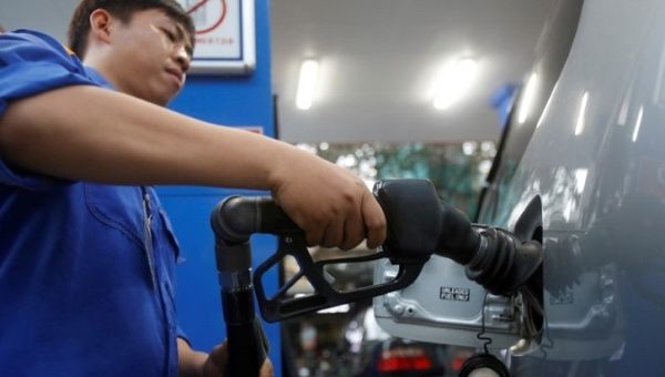 An employee pumps petrol into a car at a petrol station in Hanoi, Vietnam Dec. 20, 2016.