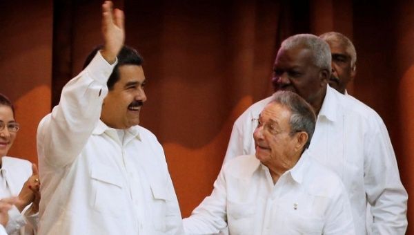 Venezuela's President Nicolas Maduro (L), waves beside Cuba's President Raul Castro at an event in Havana last year.