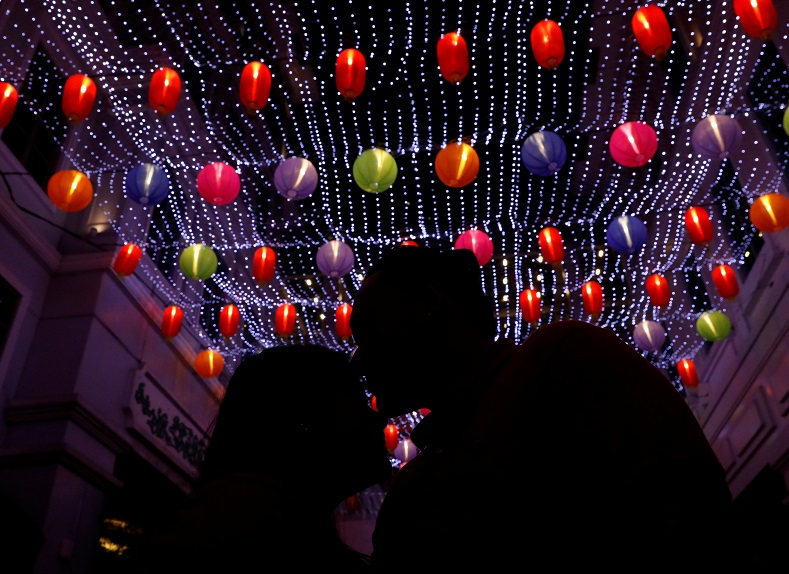 Chinese lanterns dangle above a romantic couple as they share a New Year kiss in the Binondo district of Manila, in the Philippines.