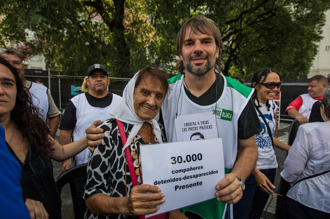 ATE union leader, Daniel Catalano, protests alongside Grandmothers of the Plaza Mayor member, Taty, today in Argentina to protest Macri's austerity measures and to call for the remaining 30,000 detained and disappeared in Argentina to be returned home. 