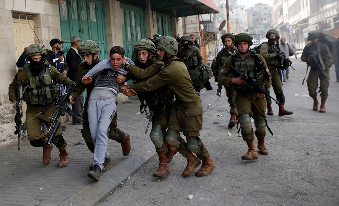 Israeli soldiers detain a Palestinian during clashes at a protest in Hebron, in the occupied West Bank.