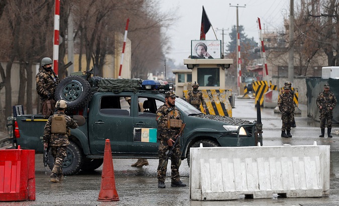 Afghan security forces keep watch at a check point near the site of a suicide attack in Kabul, Afghanistan Feb. 24, 2018.