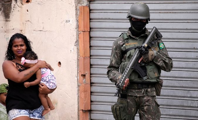 An armed forces member patrols a neighborhood in Rio de Janeiro.