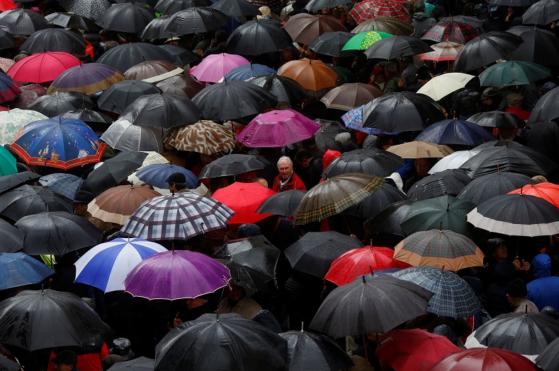 People braved the rain to protest against government plans.