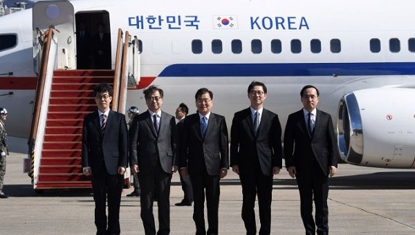 Members of South Korean delegation pose before boarding an aircraft as they leave for Pyongyang at a military airport in Seongnam, South Korea March 5, 2018.