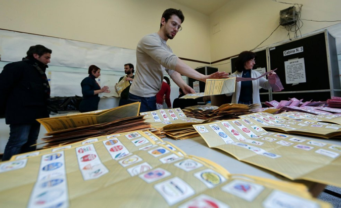 Voting officials count the ballots at a polling station in Rome on Monday at the end of the second day of Italy's national elections.