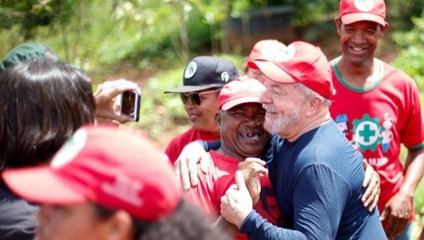 Former Brazilian President Luiz Inacio Lula da Silva (Right) is greeted by a member of the Rural Landless Movement.