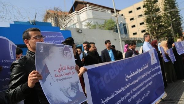 Palestinian journalists hold a protest against recent Facebook censorship of Palestinian accounts in Gaza City.