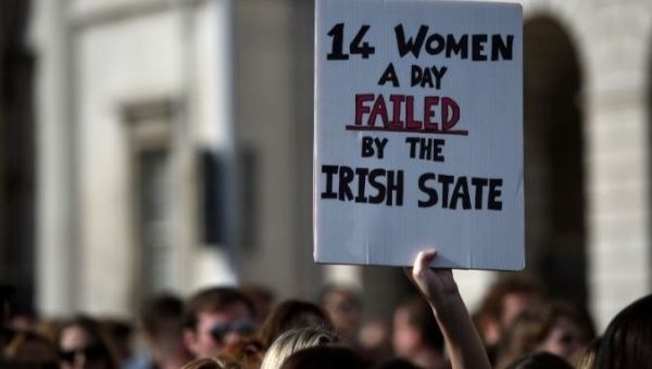 Demonstrators hold posters as they march for more liberal Irish abortion laws in Dublin, Ireland.