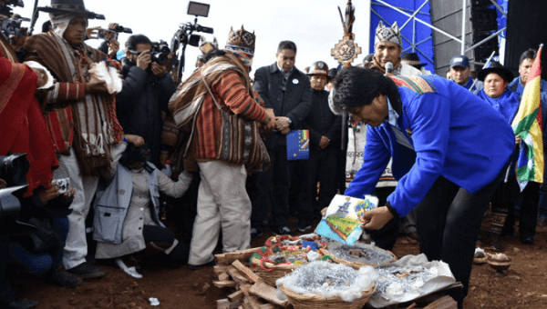 Evo Morales leaves an offering during an inter-religious ceremony.