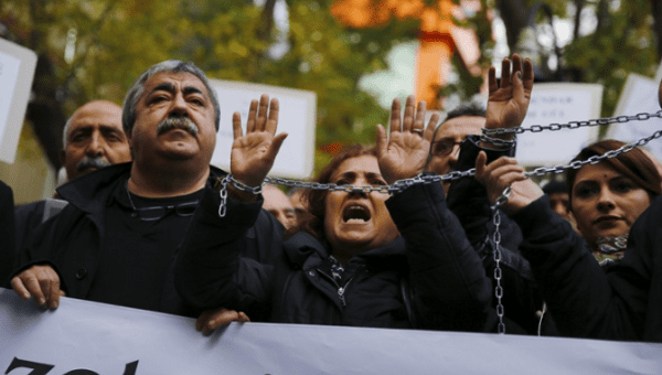  Demonstrators raise their chained hands during a protest over the arrest of journalists Can Dundar and Erdem Gul in Ankara, Turkey, on Nov. 27, 2015.