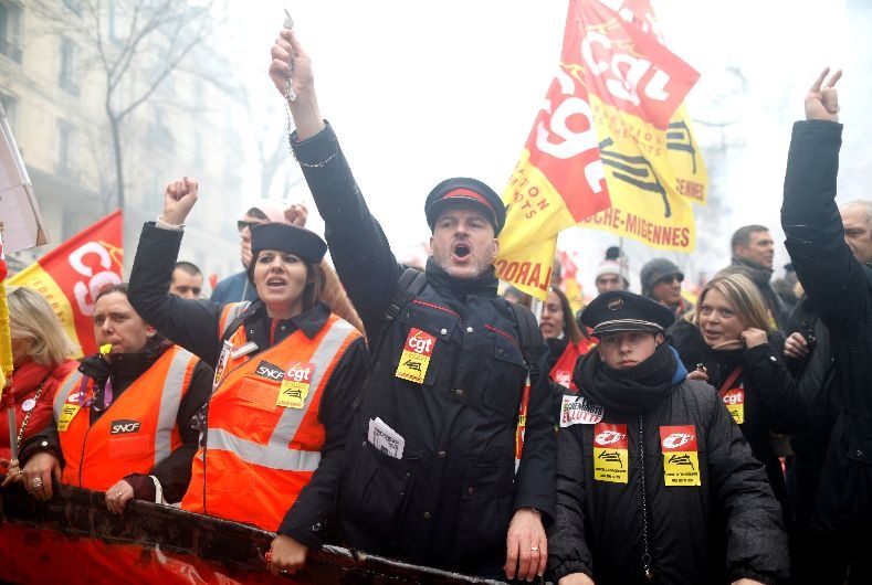 Railway workers and protestors attend a demonstration during a national day of strike against reforms in Paris, France.