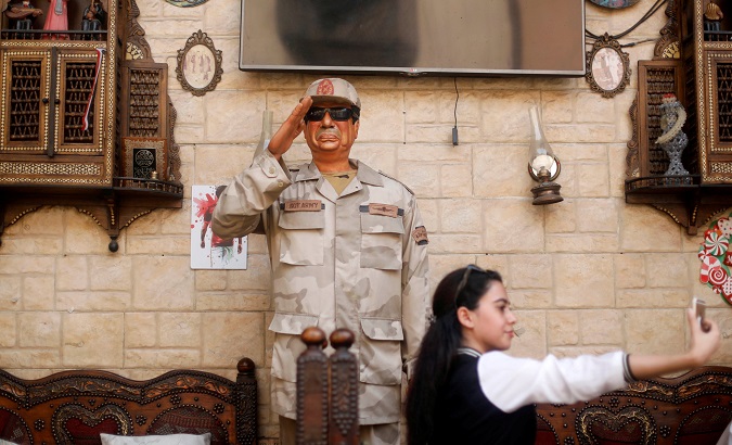 A woman takes a selfie with an effigy depicting Egyptian President Abdel Fattah al-Sisi during the second day of the presidential election in Cairo, Egypt, March 27, 2018.