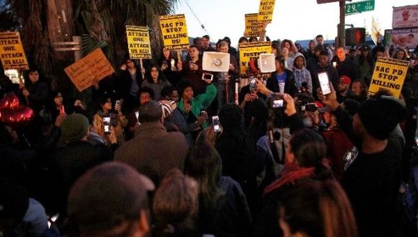 Demonstrators march to protest the police shooting of Stephon Clark, in Sacramento, California.