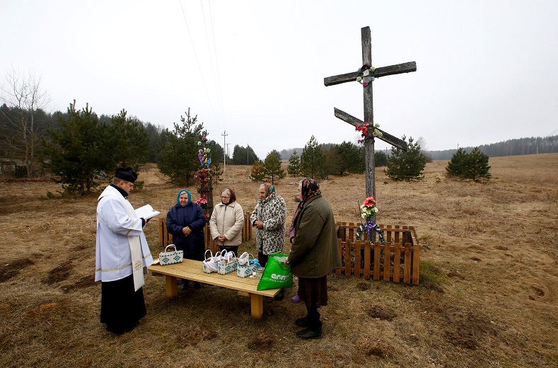 A Catholic priest conducts a service on the eve of Easter Sunday in the village of Zhykhi, Belarus, March 31. 